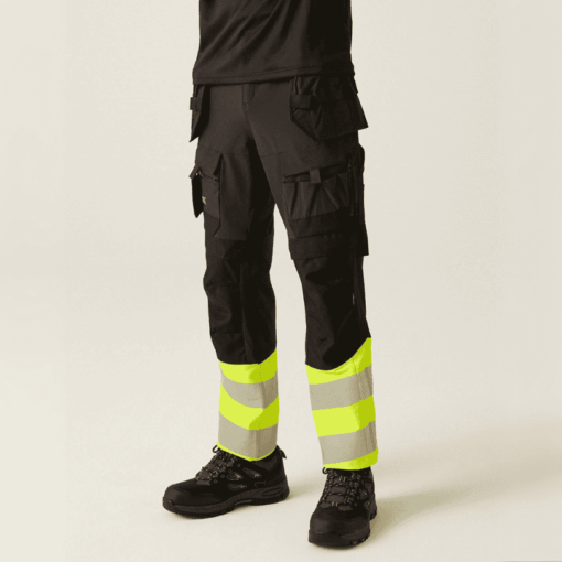 Front view model wearing yellow Regatta Hi-Vis Workwear Trousers